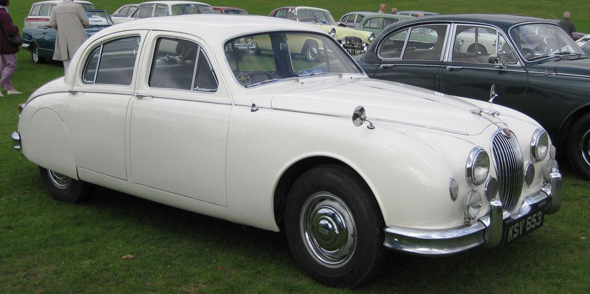 A 1959 Jaguar 2.4 litre Mk 1 with spats next to a Jaguar Mk 2 
